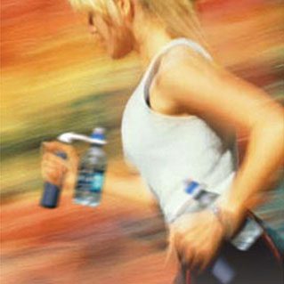 A woman running with water bottle in her hand.